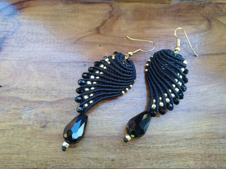 Black and golden macram\u00e8 earrings in wings shape