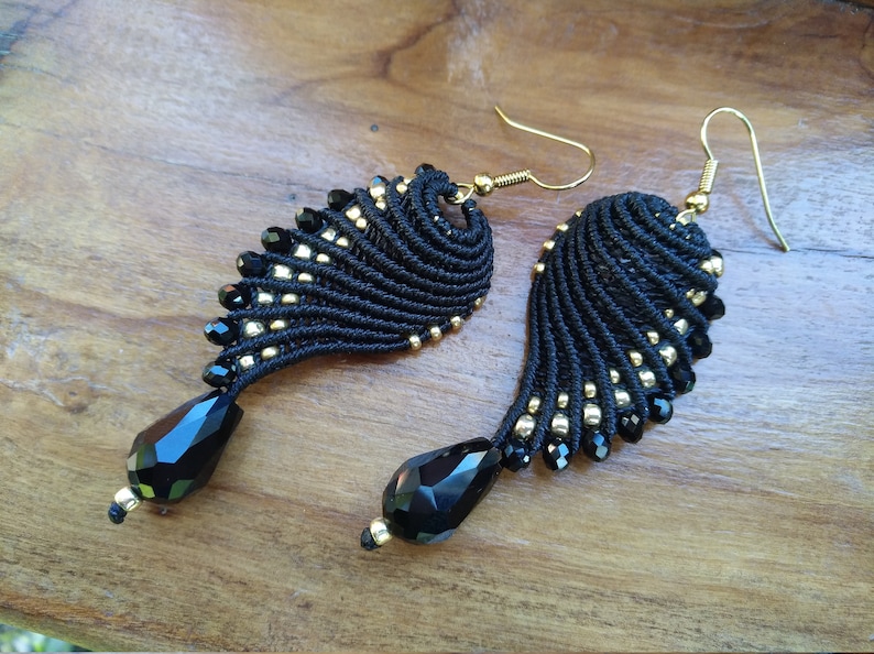 Black and golden macram\u00e8 earrings in wings shape
