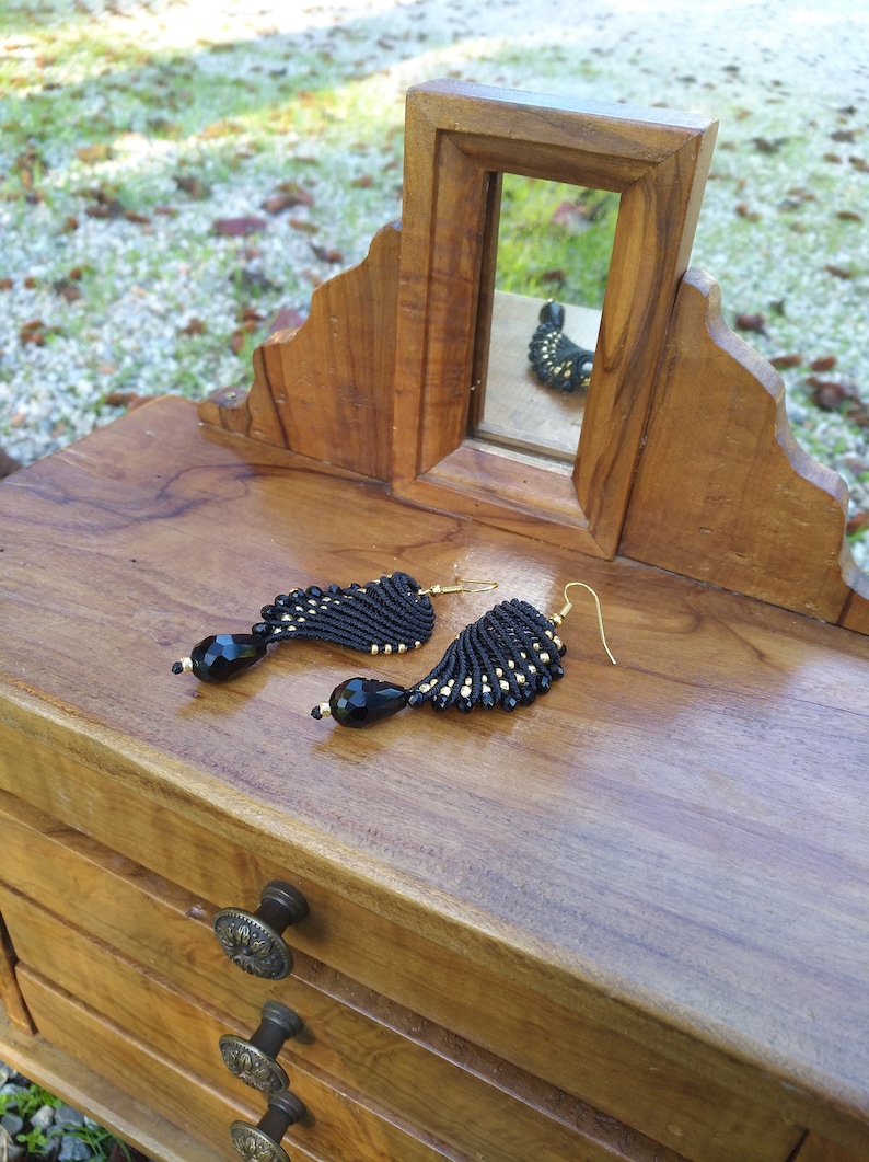 Black and golden macram\u00e8 earrings in wings shape