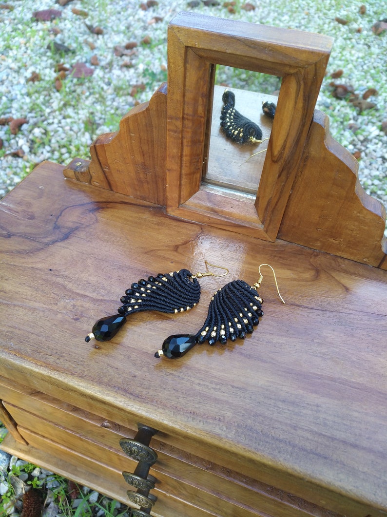 Black and golden macram\u00e8 earrings in wings shape