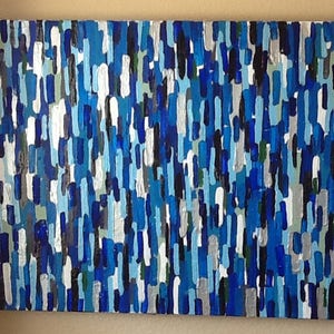 May include: Abstract painting featuring a blue, white and black colour scheme. The painting is composed of numerous vertical lines of varying widths and lengths.