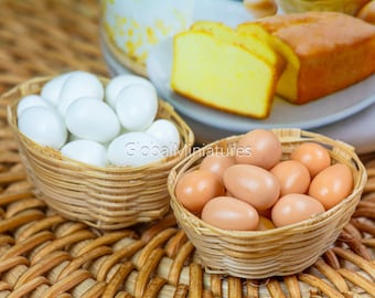 May include: Two wicker baskets filled with miniature eggs. One basket contains white eggs and the other contains brown eggs.