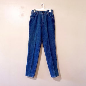 May include: A pair of blue denim jeans with a high waist and straight legs.
