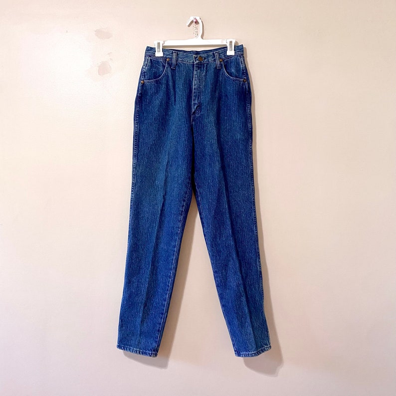 May include: A pair of blue denim jeans with a high waist and straight legs.