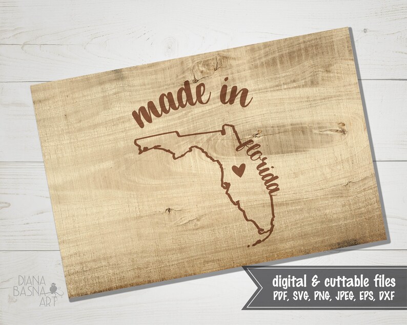 May include: A wooden sign with the words "made in Florida" and a heart-shaped graphic. The sign features a map outline of Florida. The sign is made of light-colored wood and has a rustic appearance. The bottom right corner of the sign has the text "digital & cuttable files".
