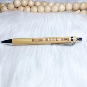 May include: A wooden pen with a silver clip and a silver tip. The pen has the words "Never forget the difference you make!" engraved on the side.