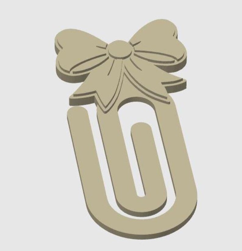 May include: A beige paperclip with a bow design at the top. The bow has detailed lines and a circular center. The paperclip is a U-shape with a rounded bottom. The design is simple and elegant.