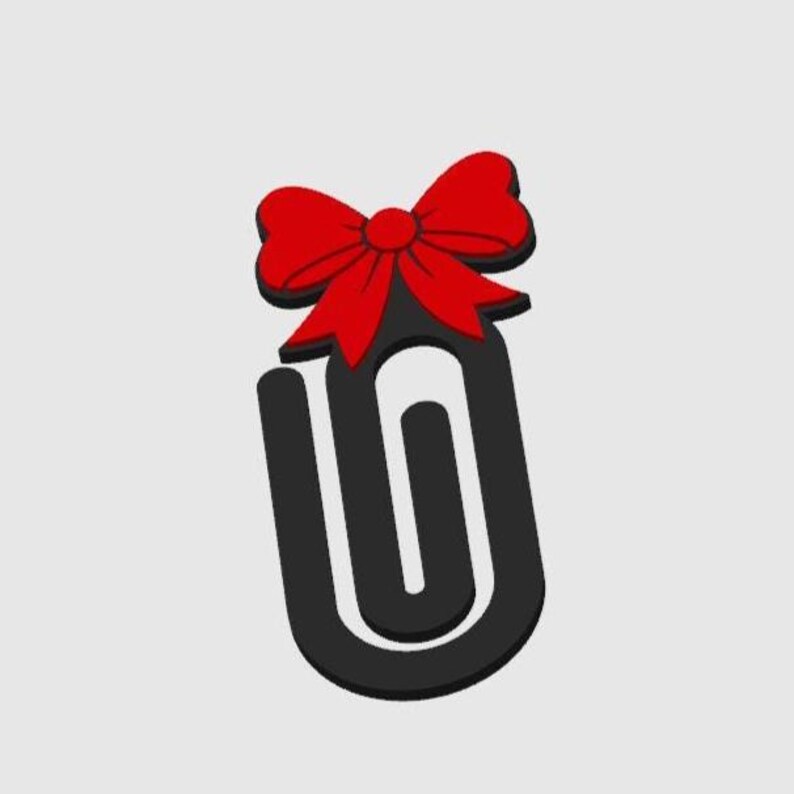 May include: A black paperclip with a red bow on top. The bow is a vibrant red with a darker red outline, and the paperclip is a solid black color. The background is a plain, light gray.