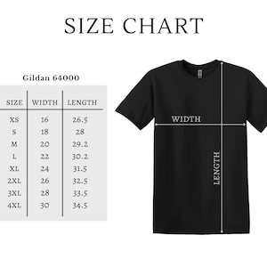 May include: A black t-shirt displayed next to a Gildan 64000 size chart. The chart lists sizes from XS to 4XL with corresponding width and length measurements in inches. White lines on the t-shirt indicate where the width and length are measured.