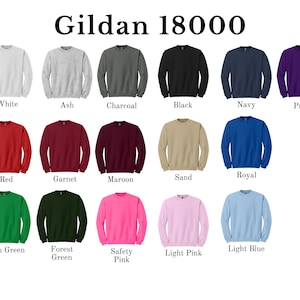 May include: A Gildan 18000 color chart featuring seventeen long-sleeve crewneck sweatshirts in various solid colors including white, ash, charcoal, black, navy, purple, red, garnet, maroon, sand, royal, irish green, forest green, safety pink, light pink, and light blue.