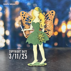May include: A wooden fairy figurine with brown butterfly wings, a green dress, and a golden star wand. The fairy has blonde hair and is standing on a green base. The text "COPYRIGHT DATE 3/11/25" is visible in the image.