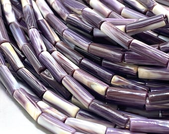 May include: A collection of cylindrical beads featuring a smooth, polished finish with a marbled pattern of deep purple, lavender, and creamy white tones. Each bead has a consistent tubular shape, showcasing natural variations in color and texture.