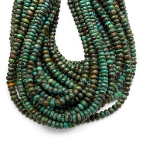 May include: A collection of multiple strands of small, round, disc-shaped turquoise beads. The beads feature a variegated color palette of deep teal, forest green, and earthy brown tones with natural dark matrix veining throughout.