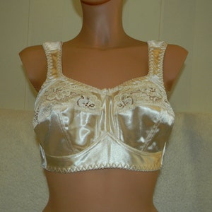 May include: A white satin bra with lace trim. The bra has adjustable straps and a hook and eye closure at the back.