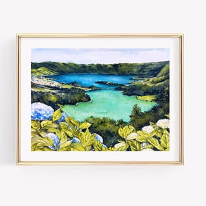 May include: Watercolour painting of a scenic landscape featuring a turquoise lake surrounded by lush green hills and vegetation. Blue and white flowers are in the foreground. The artwork is framed in a gold-coloured frame.
