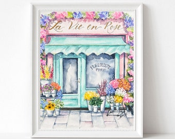 May include: A watercolor painting of a flower shop storefront with a teal awning and the words "La Vie en Rose" above the door. The shop window says "Fleuriste Paris" and is filled with colorful flowers.