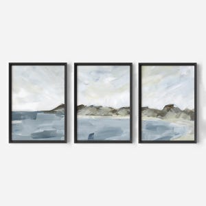 May include: Set of three framed abstract landscape paintings. Each piece features a coastal scene with blue water, brown hills, and a cloudy sky. The artwork is in a modern style with a minimalist aesthetic.