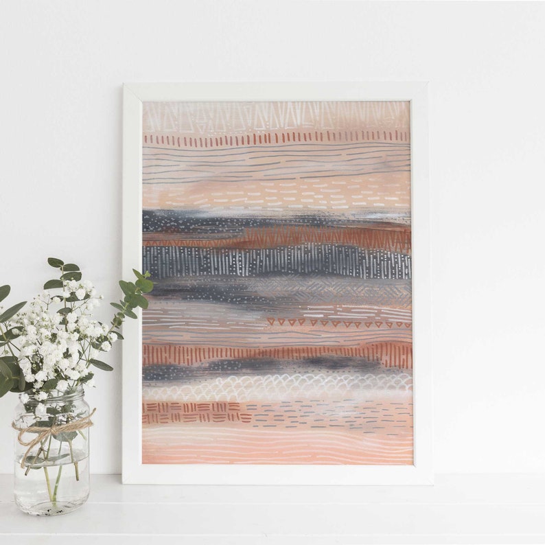 May include: A framed abstract art print with a layered design of horizontal stripes in shades of pink, brown, gray, and white. The print features a variety of geometric patterns and textures.