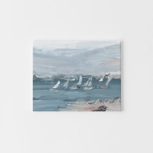 May include: A painting depicting a seascape with sailboats in the distance. The sky is a light blue with a few clouds. The water is a darker blue and the beach is a light brown.
