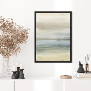 May include: A framed abstract painting with a muted color palette of beige, blue, and green. The painting depicts a landscape with a horizon line and a body of water.