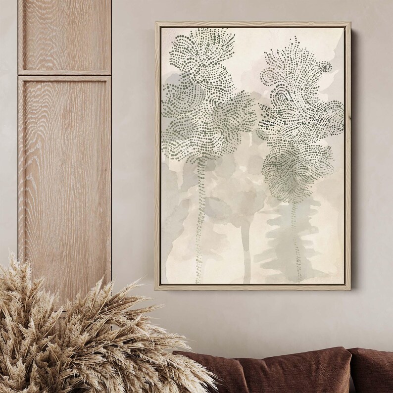 May include: A framed abstract art print with a beige background and two stylized trees in shades of green. The trees are made up of small dots and are set against a watercolor-like background.