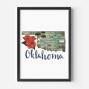 May include: A green outline of the state of Oklahoma with the names of cities and towns inside. The outline is decorated with red roses, buffalo, and other imagery. The word "Oklahoma" is written in blue cursive at the bottom.