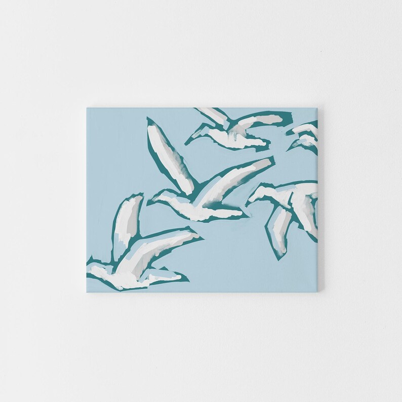 May include: A blue and white abstract art print featuring a flock of birds in flight. The birds are painted in a stylized, minimalist style, with a focus on their wings and movement.