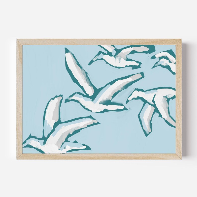 May include: A framed print of a minimalist abstract painting featuring white birds flying against a light blue background. The birds are painted in a simple, stylized manner, with their wings outstretched and their bodies outlined in a dark teal color.