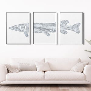 May include: Set of three framed prints featuring a stylized blue fish design. The fish is made up of a series of small lines, creating a textured look. The prints are set against a white background.