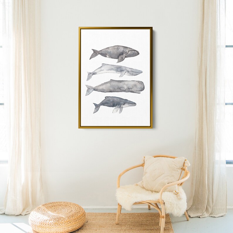 May include: A watercolor painting of five whales in shades of gray, arranged vertically in a gold frame. The whales are depicted in a realistic style, with their bodies and tails gracefully curved.