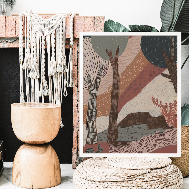 May include: Abstract art print featuring a stylized forest scene with trees, foliage, and a deer in shades of brown, pink, and blue. The print is framed and hanging on a wall.