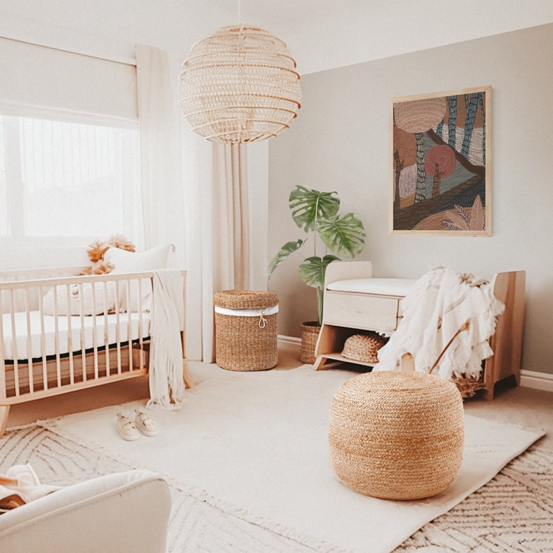 May include: A nursery room with a crib, a changing table, a wicker ottoman, and a woven basket. The walls are painted a light gray and the room is decorated in a neutral color scheme.