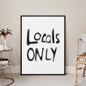 May include: Black and white framed print with the text "Locals Only" written in a bold, brushstroke font.