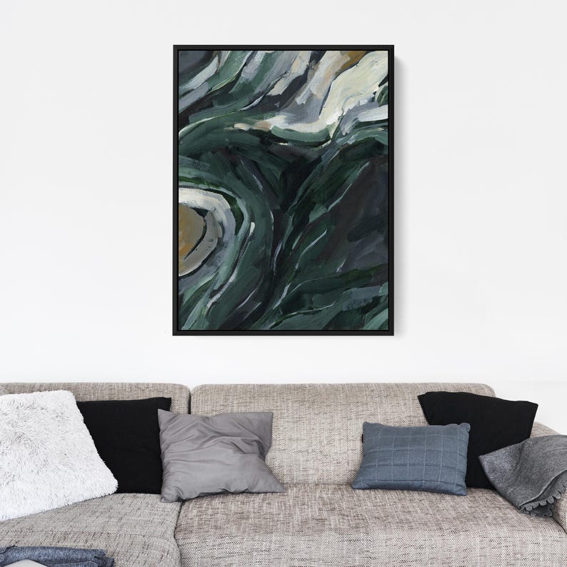 May include: Abstract painting with swirling green, blue, and white colors. The painting has a textured look and is framed in black.