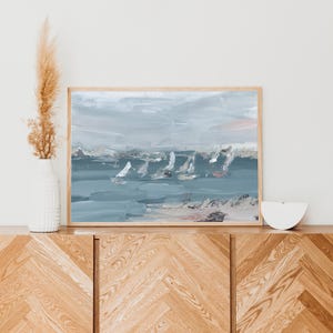 May include: Abstract painting depicting a seascape with white sailboats on a blue and grey ocean. The sky is a light blue with hints of pink and white clouds.