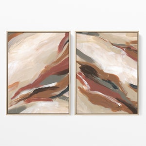 May include: Two framed abstract paintings with a beige, brown, and red color scheme. The paintings feature flowing, organic shapes and lines.