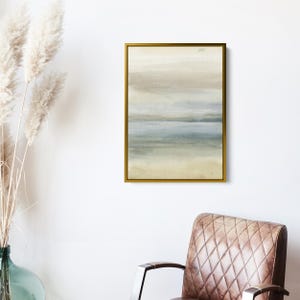 May include: Abstract watercolor painting in shades of beige, blue, and green. The painting depicts a landscape with a horizon line and layers of color. The painting is framed in a gold frame.