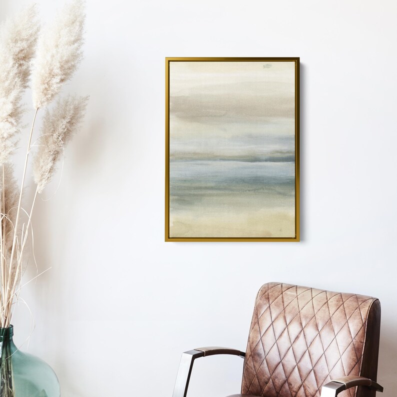 May include: Abstract watercolor painting in shades of beige, blue, and green. The painting depicts a landscape with a horizon line and layers of color. The painting is framed in a gold frame.