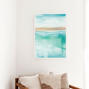 May include: Abstract watercolor painting of a seascape with a light blue sky, white clouds, a thin brown sandbar, and turquoise water.