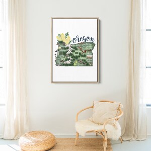 May include: A framed illustration of the state of Oregon with the word "Oregon" written in cursive at the top. The illustration is a green outline of the state with various cities and landmarks labeled in white text. The illustration includes a variety of small illustrations of animals, plants, and other objects.