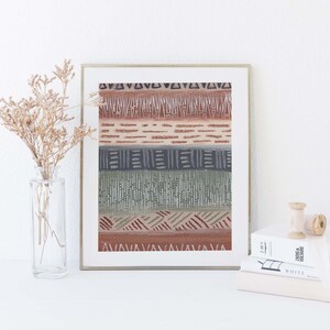 May include: A framed print with a geometric pattern in shades of brown, green, and gray. The pattern is made up of lines, triangles, and squares.
