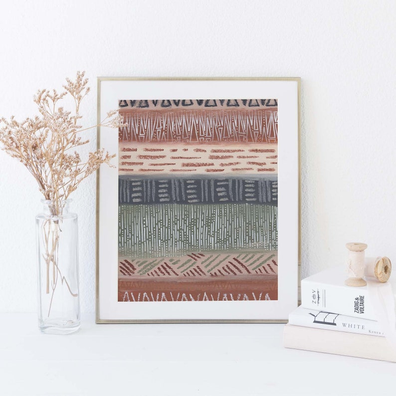 May include: A framed print with a geometric pattern in shades of brown, green, and gray. The pattern is made up of lines, triangles, and squares.