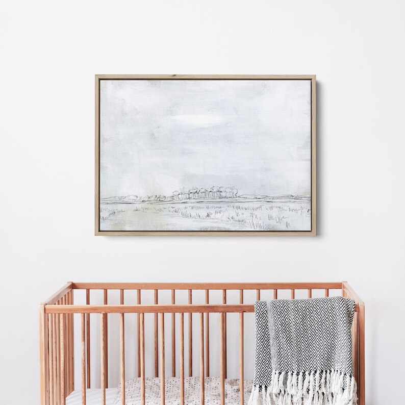 May include: A framed black and white watercolor painting of a landscape with a line of trees in the distance. The sky is a light gray and the ground is a light green.