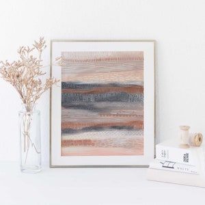 May include: A framed abstract art print with a layered design of horizontal stripes in shades of brown, gray, and white. The print has a textured look and is framed in a silver frame.