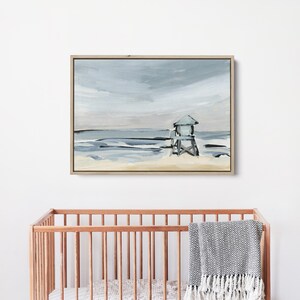 May include: A painting of a beach scene with a lifeguard stand in the distance. The sky is a light blue with gray clouds, and the water is a light blue with white waves. The sand is a light brown.