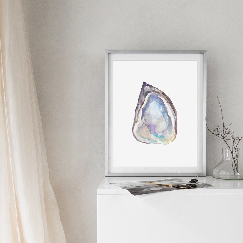 May include: A framed watercolor painting of a single oyster shell with a purple, blue, and white iridescent interior. The shell is painted in a realistic style and is set against a white background.