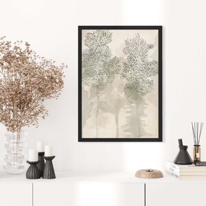 May include: A framed art print with a beige background and three abstract trees in black and white. The trees are made up of small dots and have a delicate, whimsical feel.