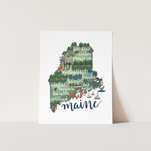 May include: A green and blue illustration of the state of Maine with the names of cities and towns throughout the state. The word "Maine" is written in large, blue cursive letters at the bottom of the image.
