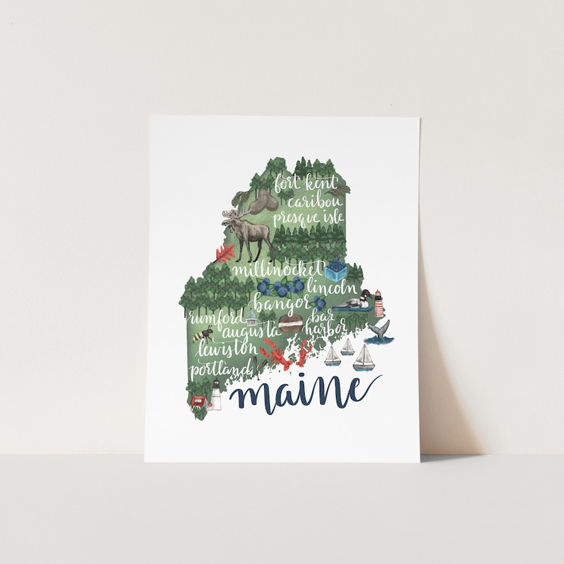 May include: A green and blue illustration of the state of Maine with the names of cities and towns throughout the state. The word "Maine" is written in large, blue cursive letters at the bottom of the image.