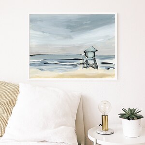May include: A painting of a beach scene with a lifeguard stand in the distance. The sky is a light blue with white clouds, and the water is a dark blue with white waves. The sand is a light brown.